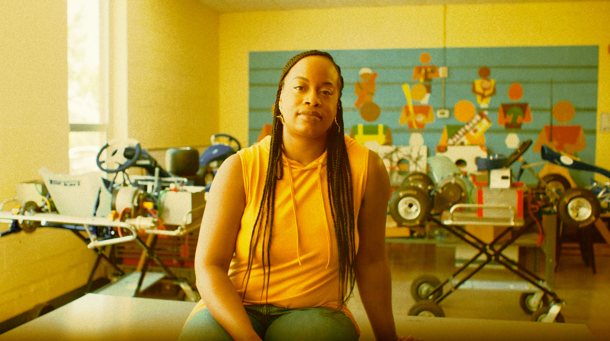 Women sitting on table inside a classroom.
