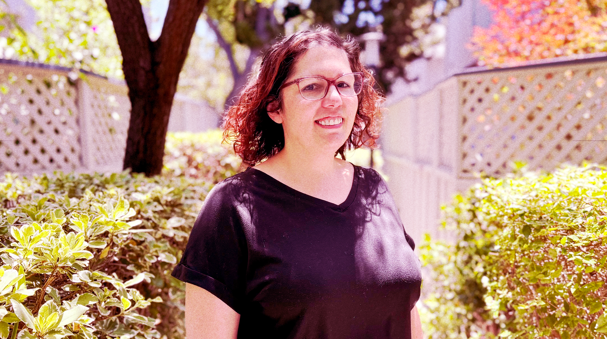 Portrait of Kristen Martin Lai in a pretty garden.