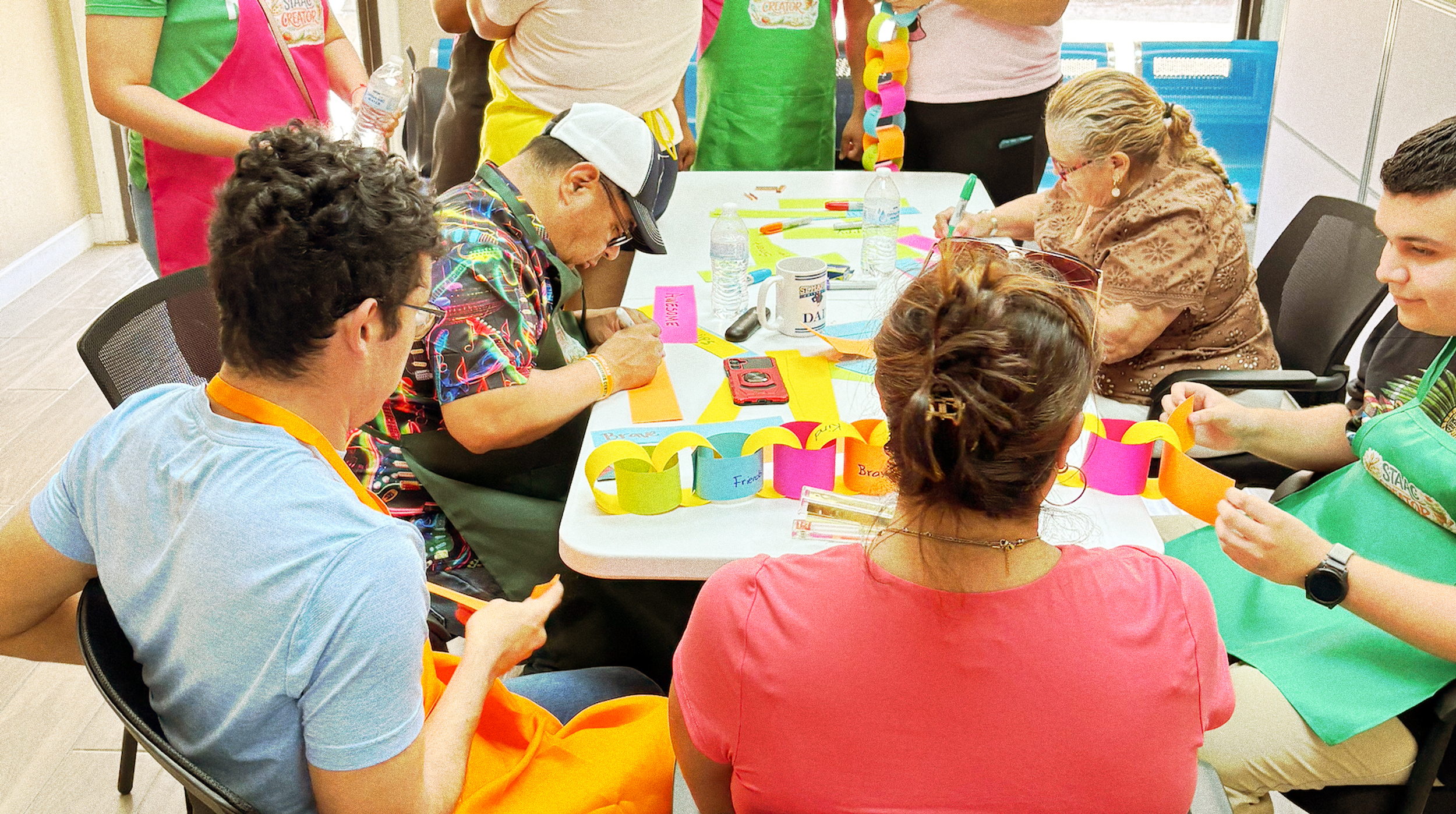 articipants at the South Texas All Abilities Center creating a paper chain during an Infinity Day celebration.